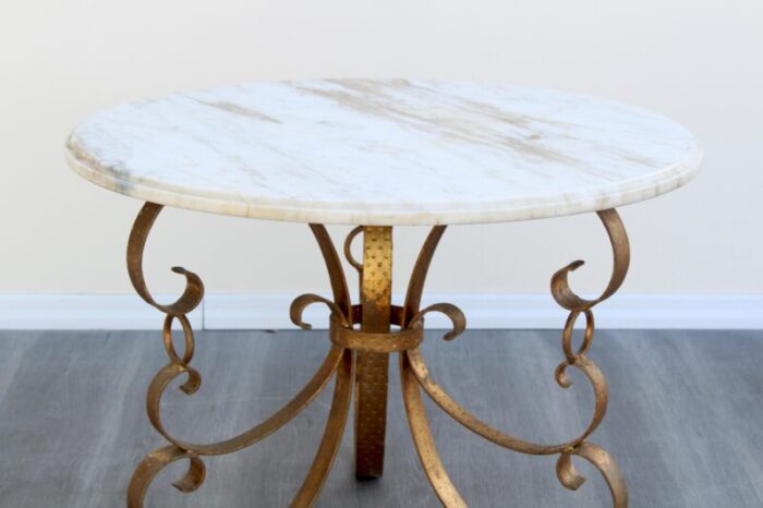 late 20th century hollywood regency metal gilt coffee table with italian marble top 7475