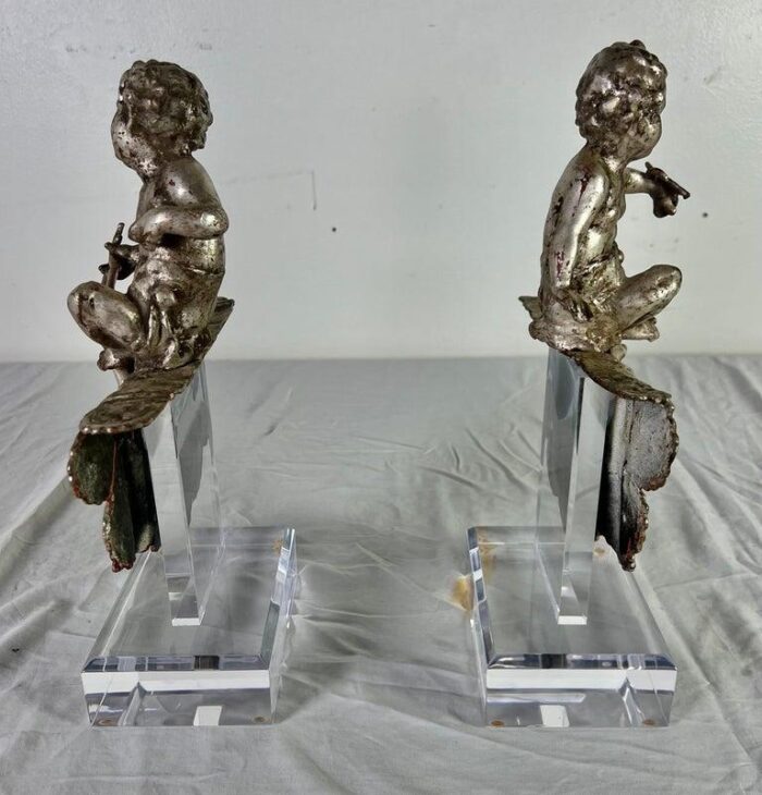 pair of french silvered gilt metal cherubs on lucite bases 1132